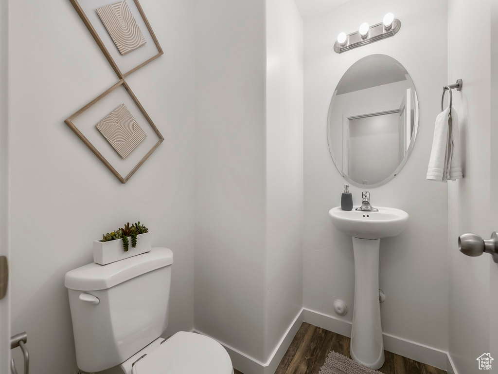 Bathroom featuring toilet and wood finished floors