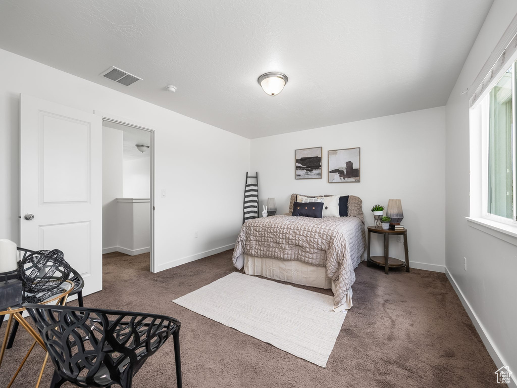 Carpeted bedroom featuring baseboards