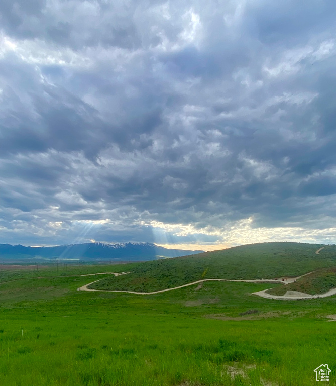 View of mountain backdrop featuring rural landscape