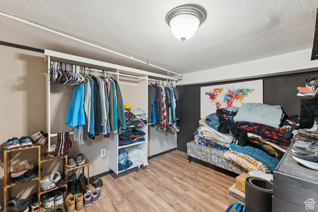Walk in closet featuring wood finished floors
