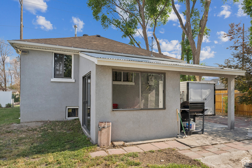Rear view of property featuring stucco siding and a patio