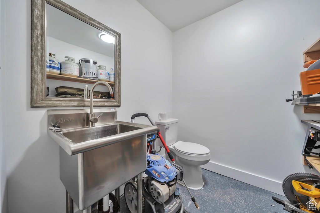 Bathroom with toilet and baseboards