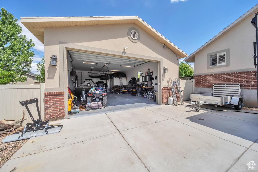 Garage featuring concrete driveway