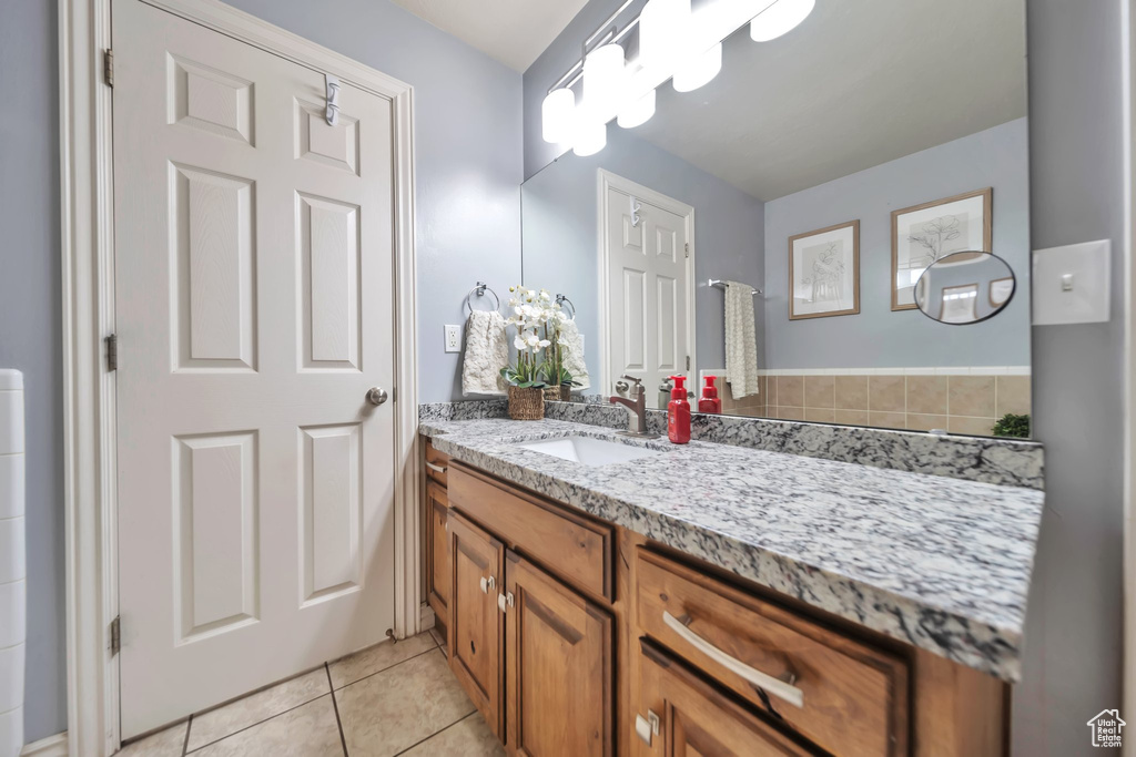 Bathroom featuring vanity and tile patterned floors