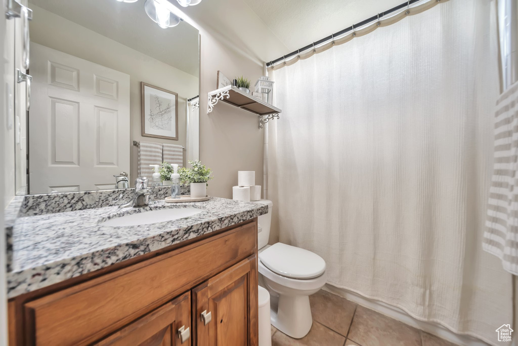 Bathroom with tile patterned flooring and vanity