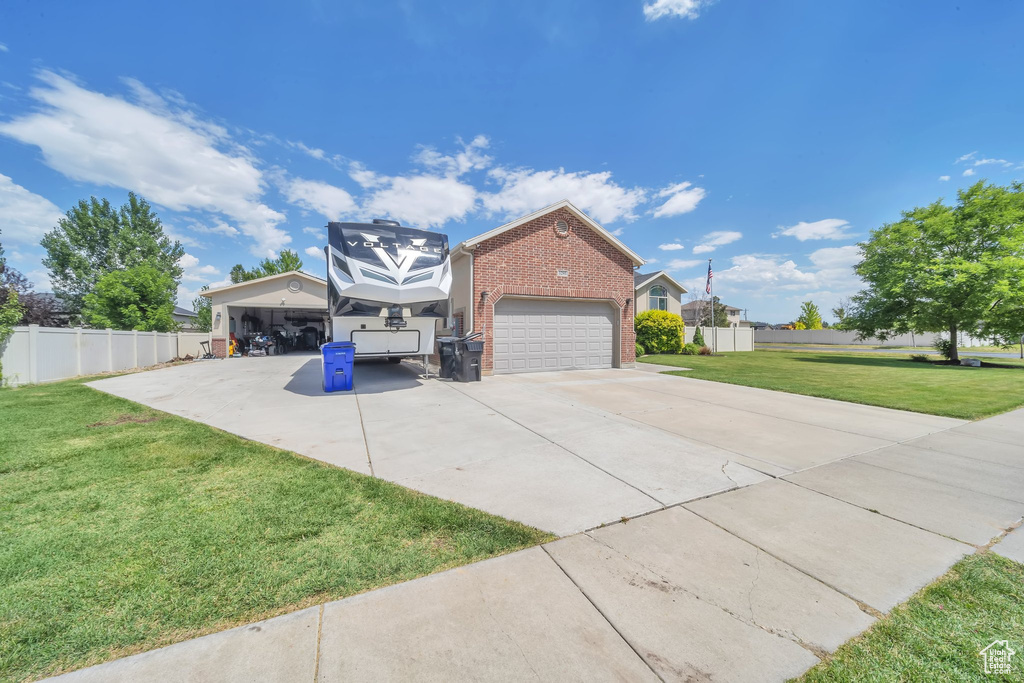 View of property exterior with brick siding, driveway, and an attached garage