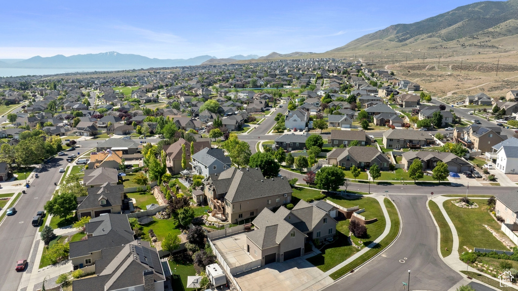 Aerial overview of property's location with a mountain backdrop and nearby suburban area