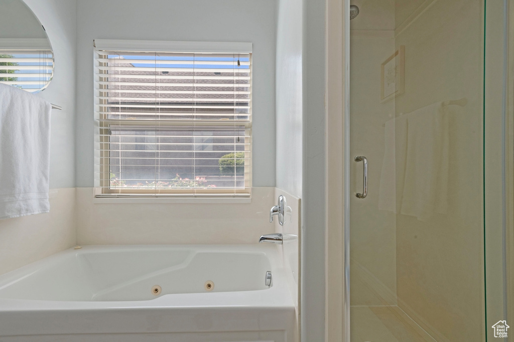 Full bathroom with a shower stall and a tub with jets