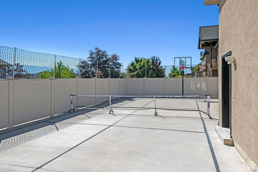 View of patio featuring a tennis court