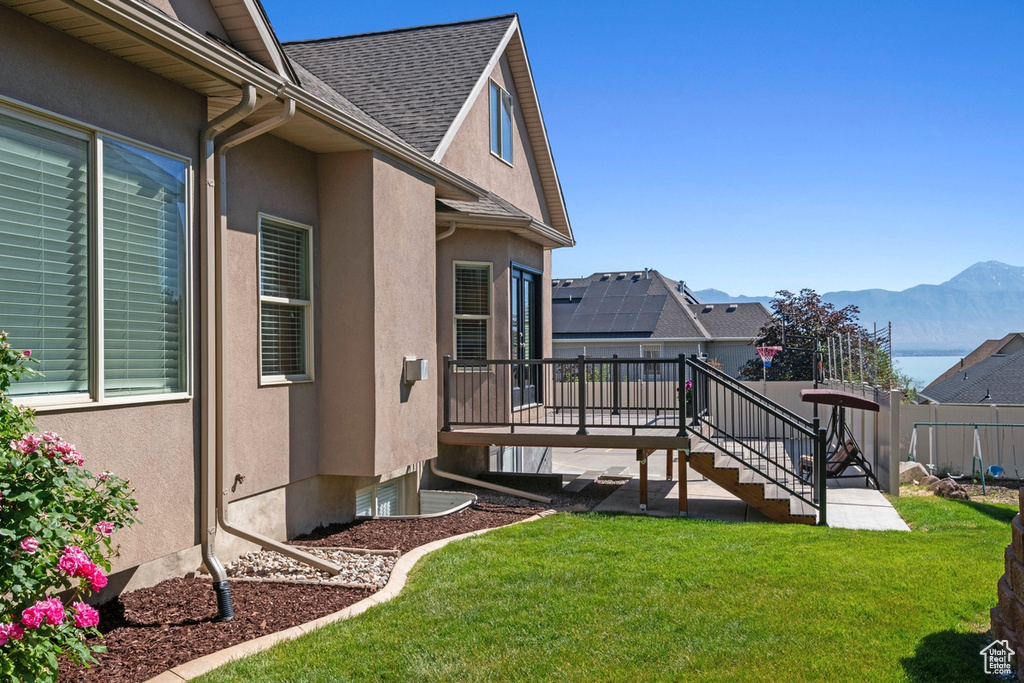 View of yard with a deck with mountain view and stairway