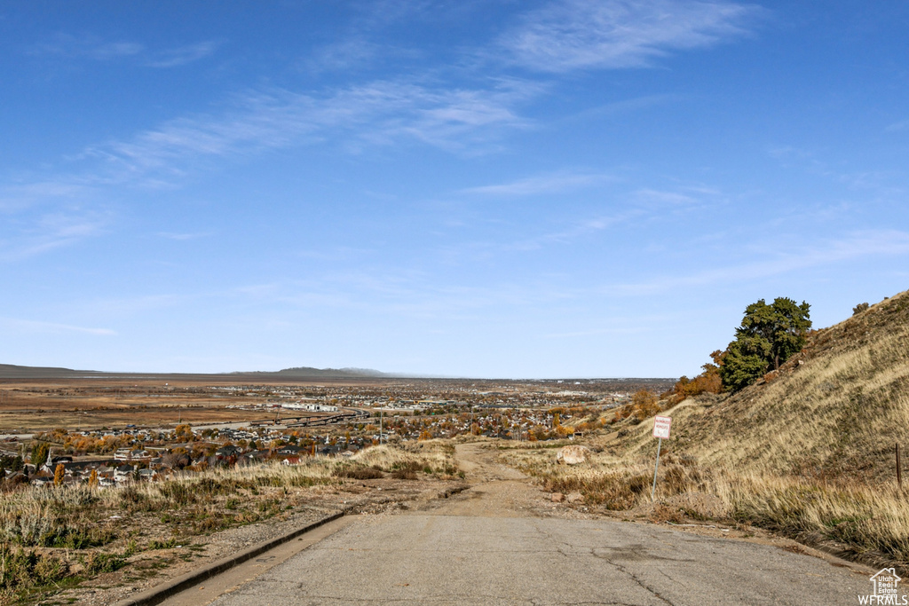 View of asphalt street featuring a mountain view and curbs