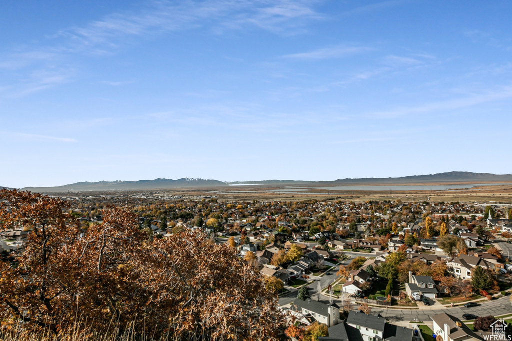Aerial overview of property's location featuring a mountain backdrop and nearby suburban area