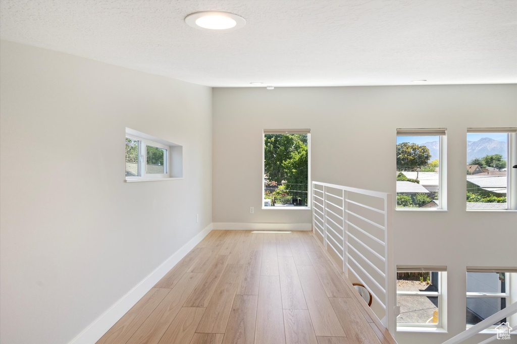 Spare room with light wood-type flooring and baseboards