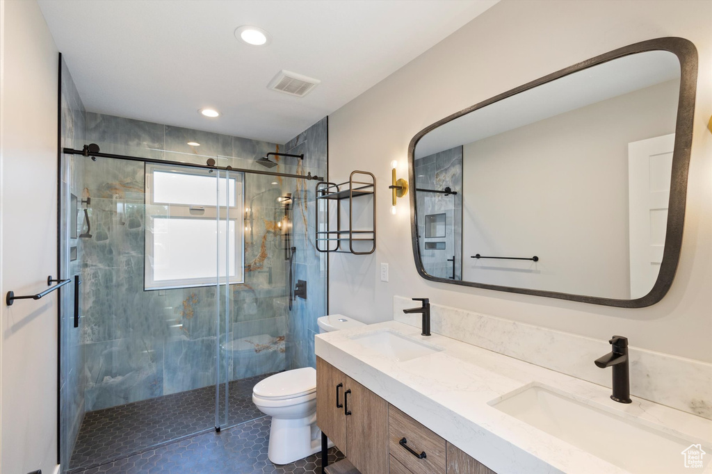 Full bathroom with double vanity, a stall shower, recessed lighting, and tile patterned floors