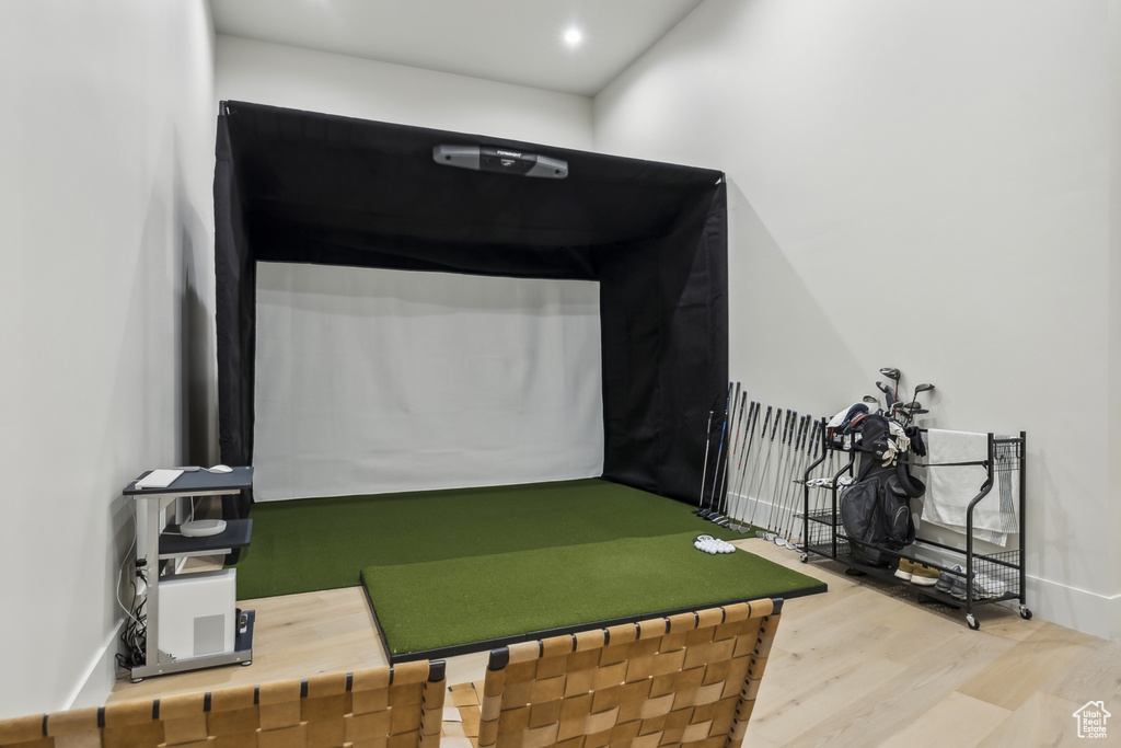 Game room featuring golf simulator, wood finished floors, and recessed lighting