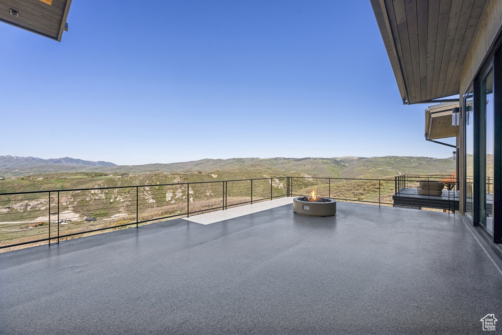View of patio / terrace featuring a mountain view and an outdoor fire pit