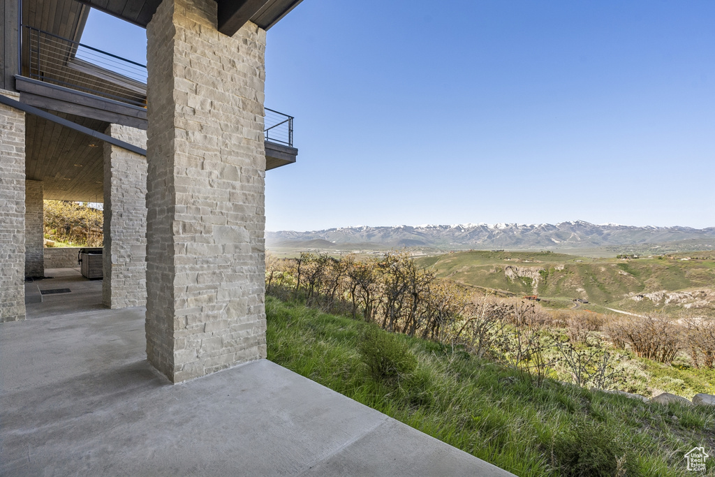 View of yard featuring a balcony, a patio area, and a mountain view