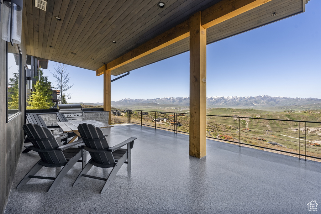 View of patio with a mountain view, area for grilling, and a view of countryside