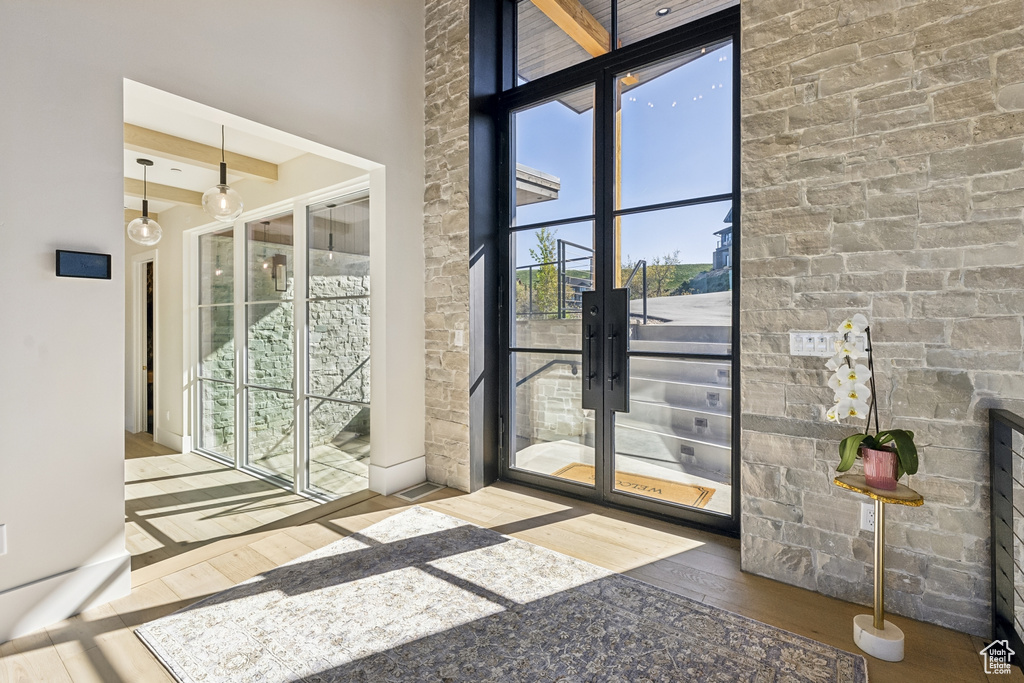 Doorway with hardwood / wood-style flooring and french doors