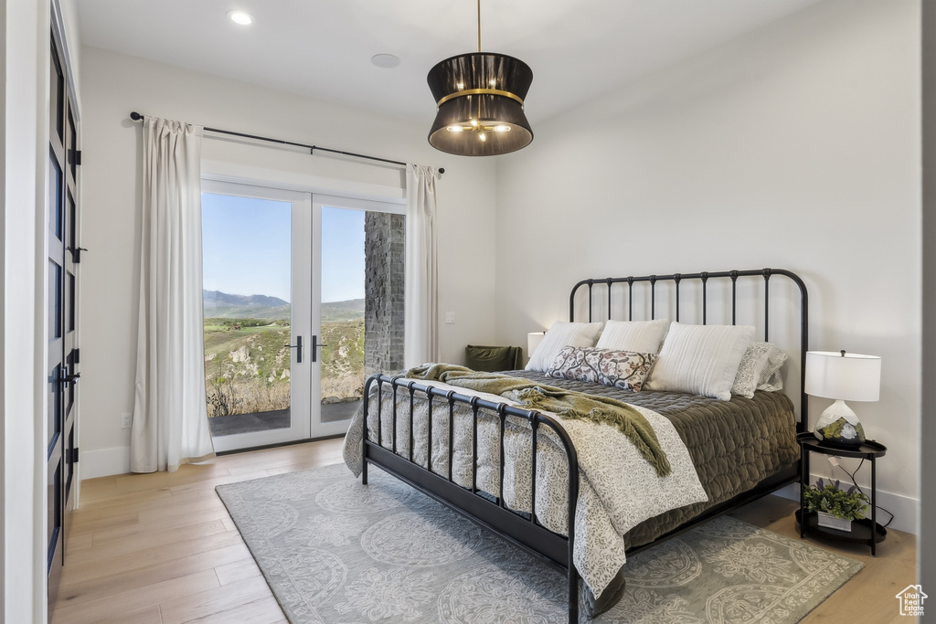 Bedroom featuring access to outside, french doors, light wood-style floors, and recessed lighting