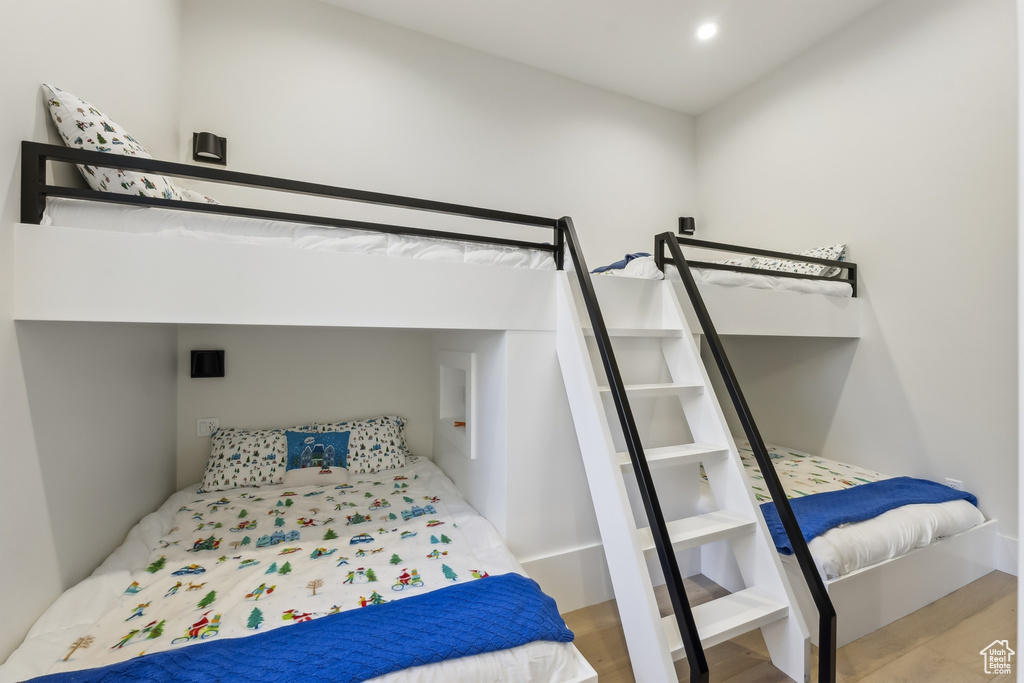 Bedroom with wood finished floors and recessed lighting