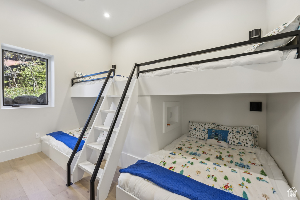 Bedroom with wood finished floors and recessed lighting