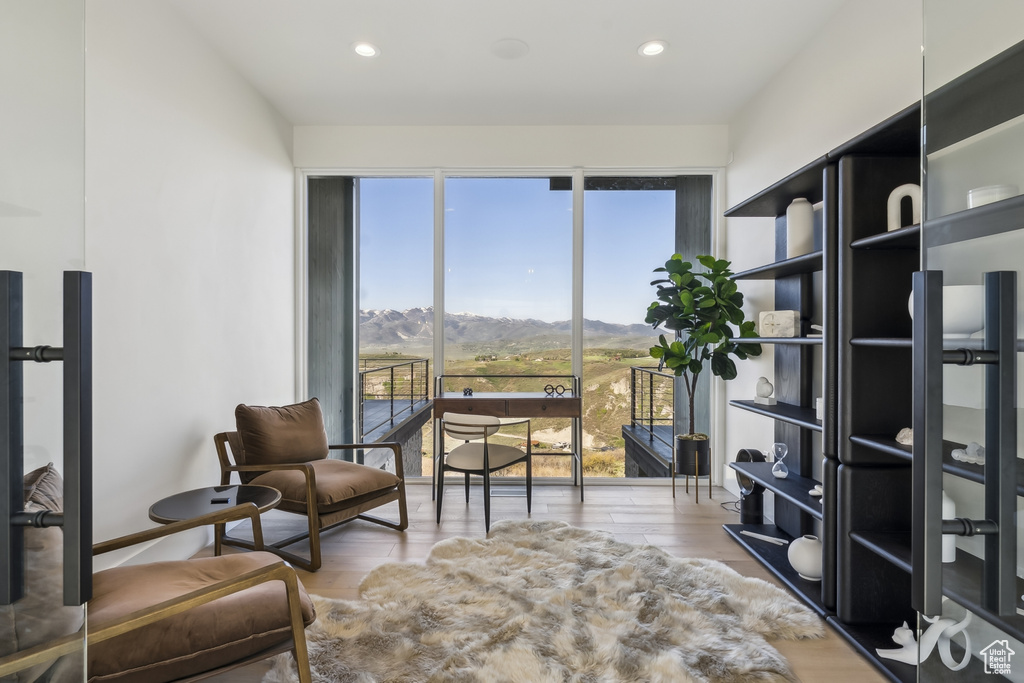 Sitting room with wood finished floors, recessed lighting, and a mountain view