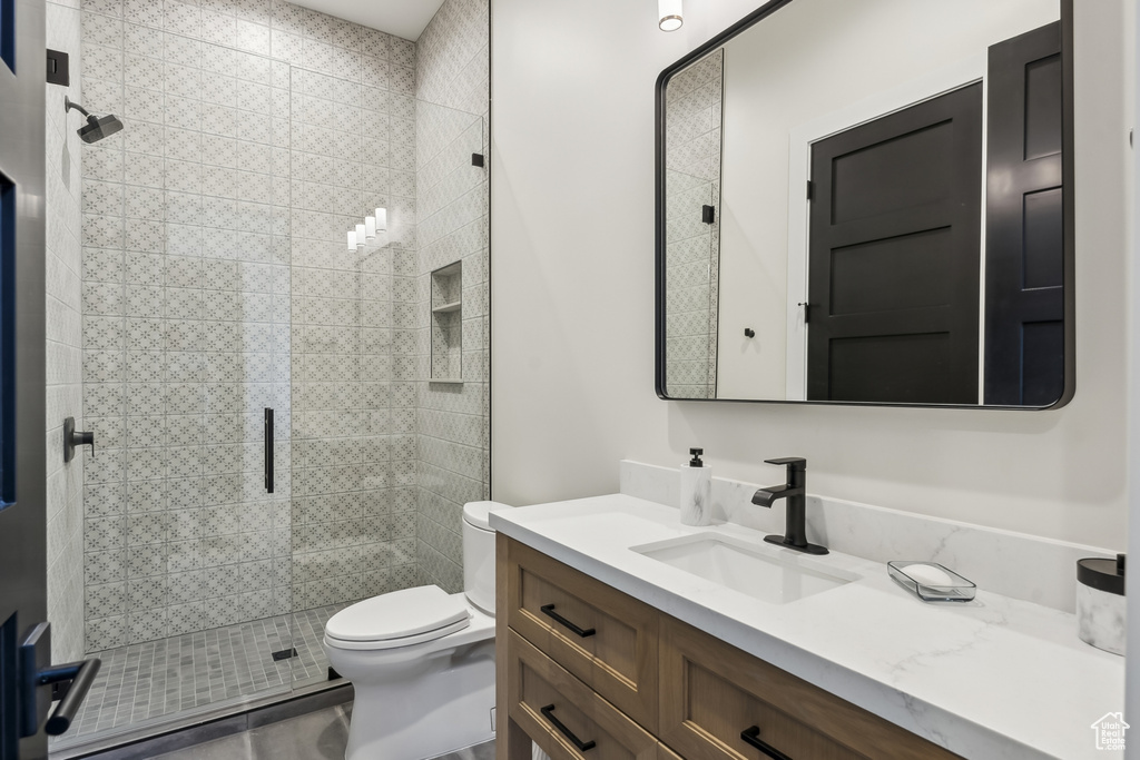 Full bath with vanity and a shower stall