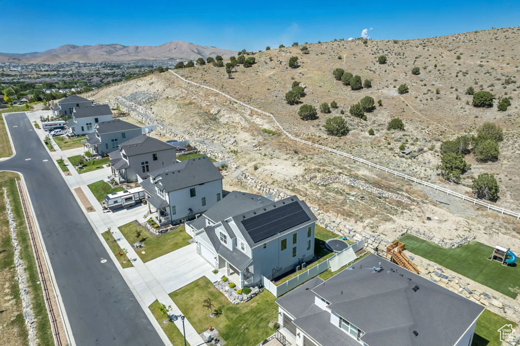 Aerial view of residential area featuring a mountainous background and a desert landscape
