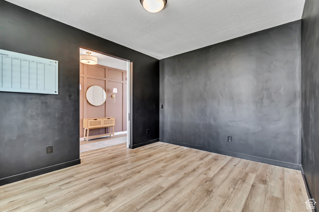 Spare room featuring wood finished floors