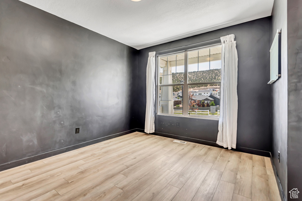 Spare room with wood finished floors and baseboards