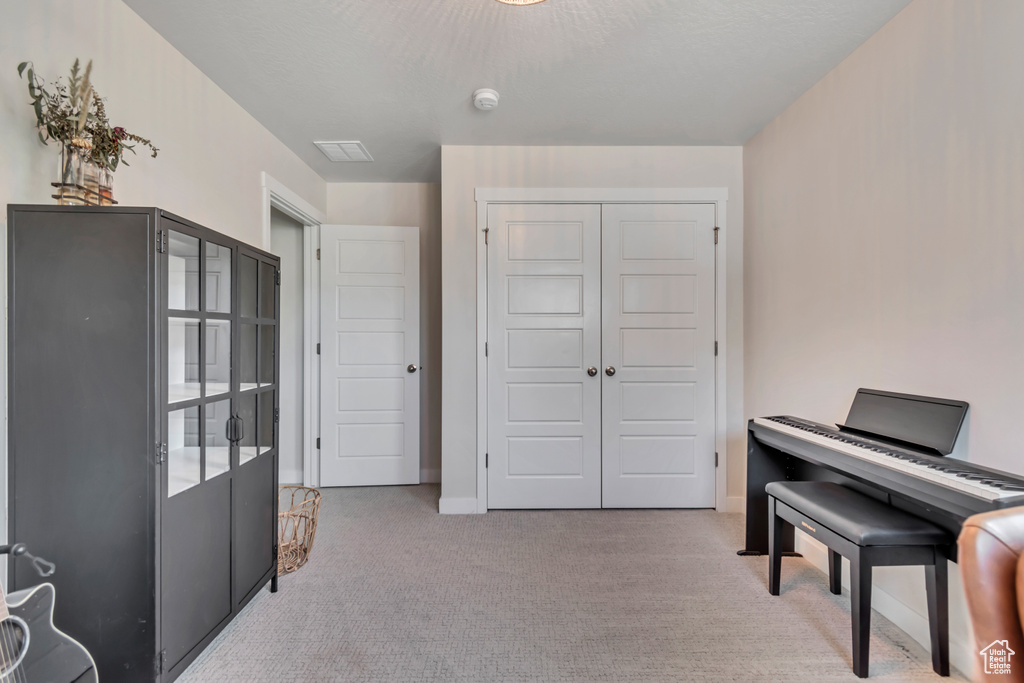 Sitting room with carpet flooring and baseboards