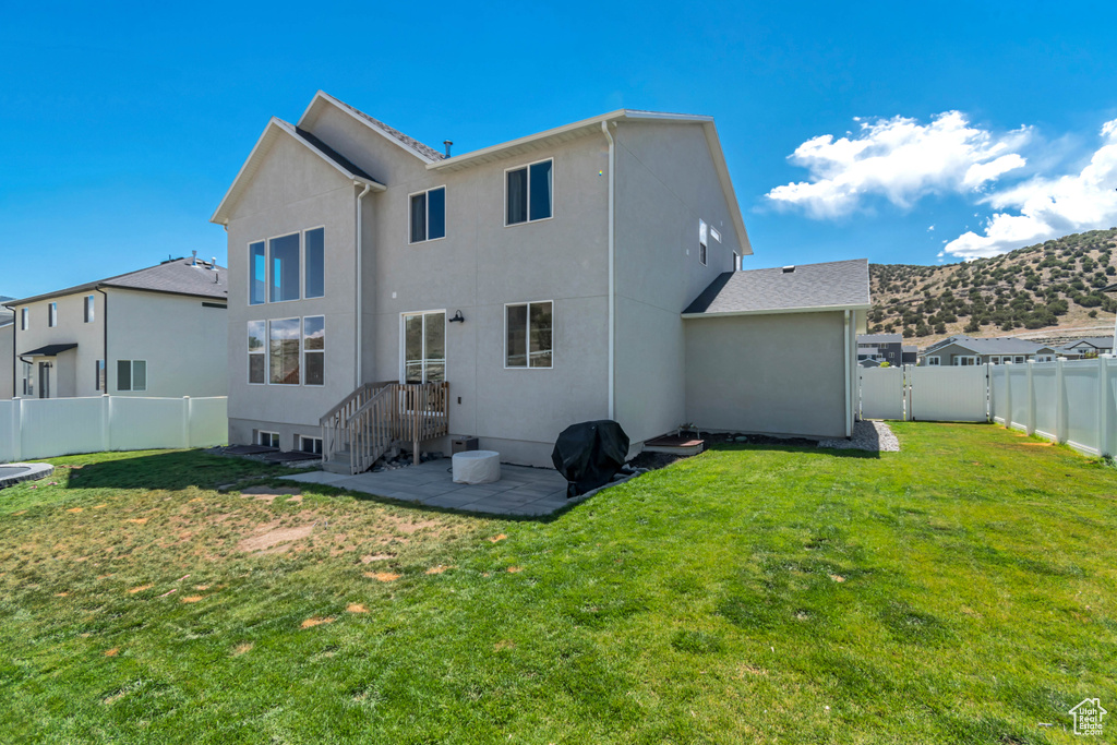 Rear view of house featuring stucco siding and a mountain view