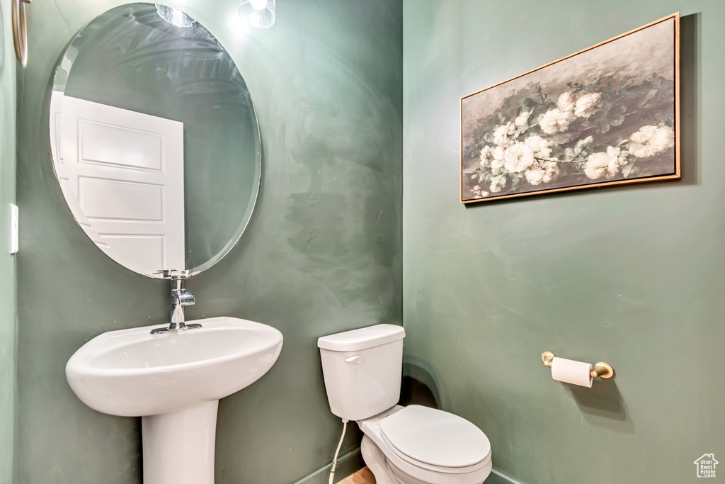 Bathroom with toilet and baseboards