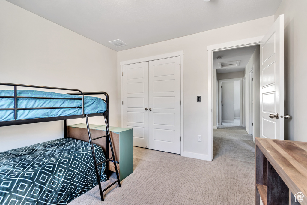 Bedroom featuring carpet, a closet, and baseboards