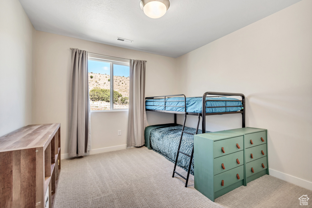 Bedroom featuring carpet flooring and baseboards