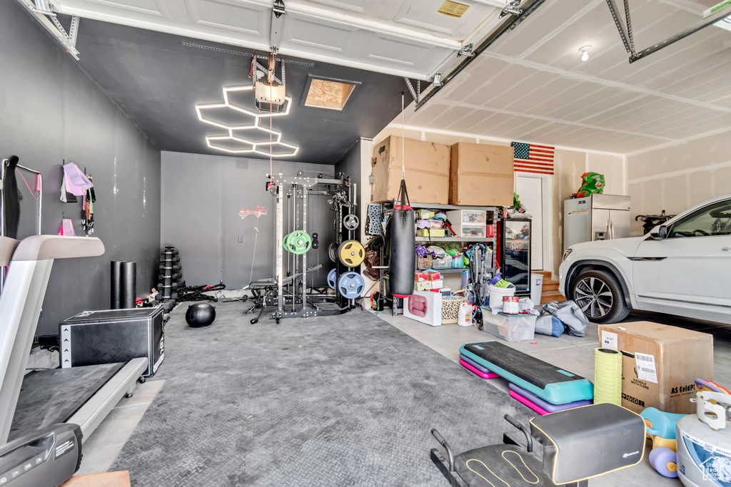 Garage featuring stainless steel fridge with ice dispenser