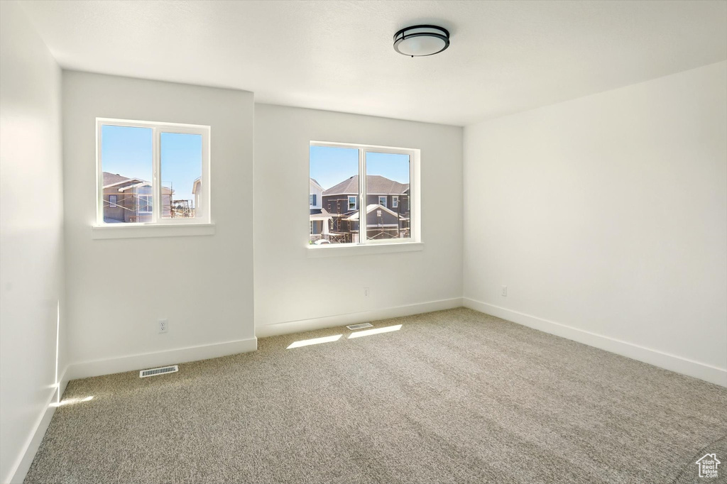 Unfurnished room with carpet floors and baseboards