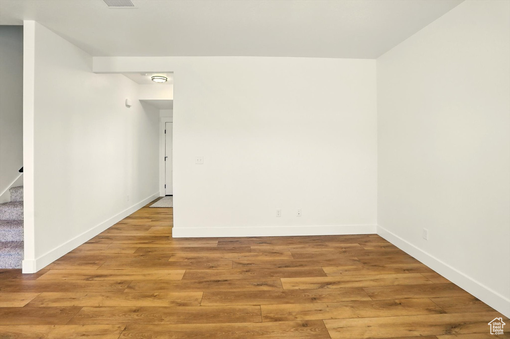 Empty room with light wood-type flooring and stairs