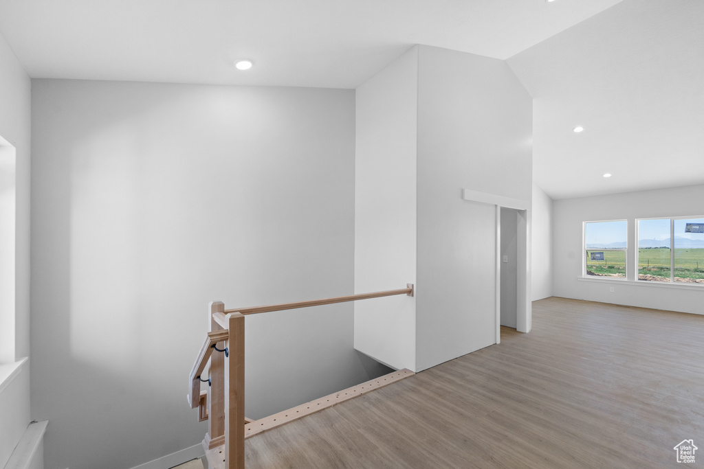 Spare room with wood finished floors and recessed lighting