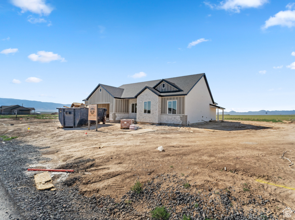Back of property with a mountain view