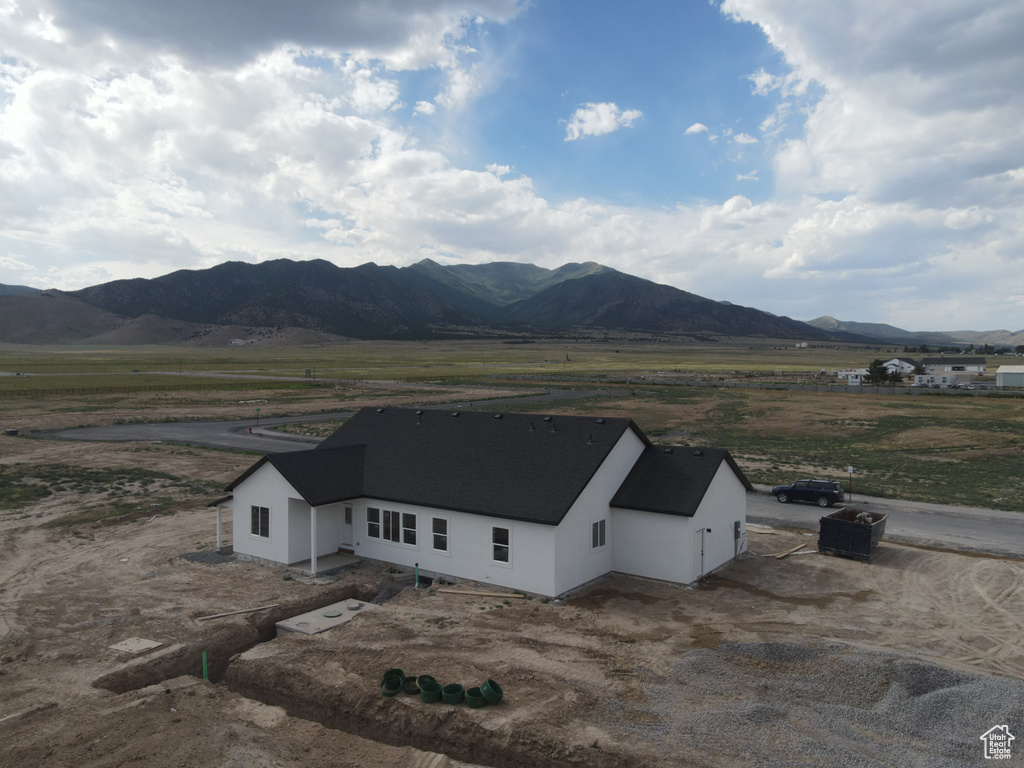 View of mountain backdrop with rural landscape