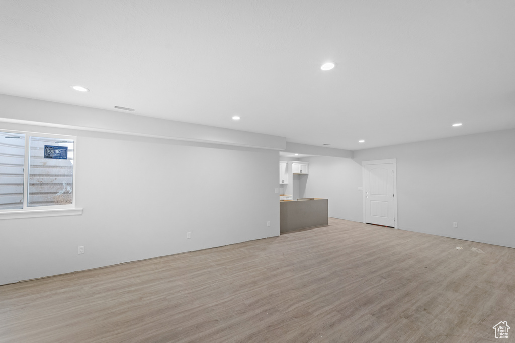 Basement featuring recessed lighting and light wood-type flooring