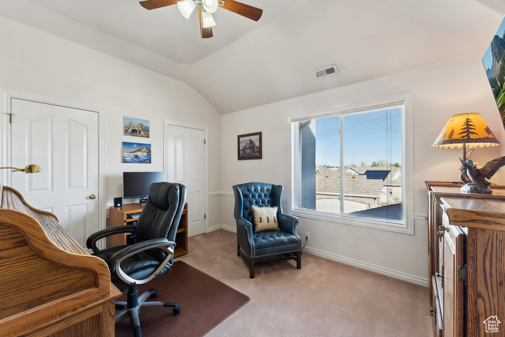 Home office with ceiling fan, lofted ceiling, and light colored carpet