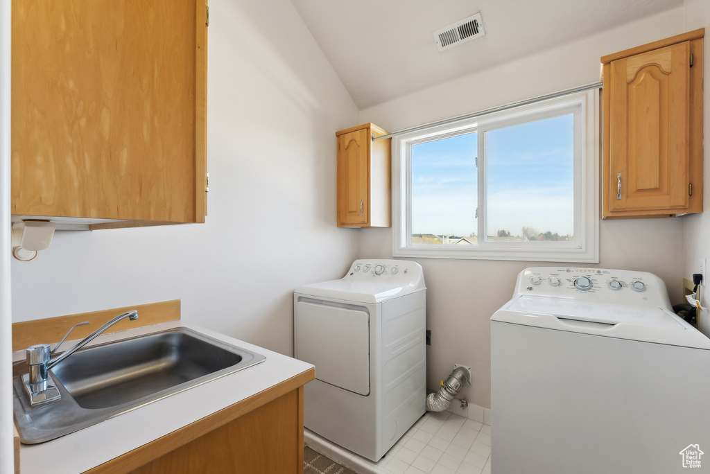 Washroom featuring cabinet space and washer and dryer