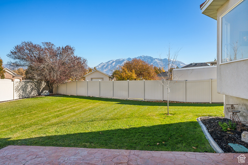 Fenced backyard featuring a mountain view