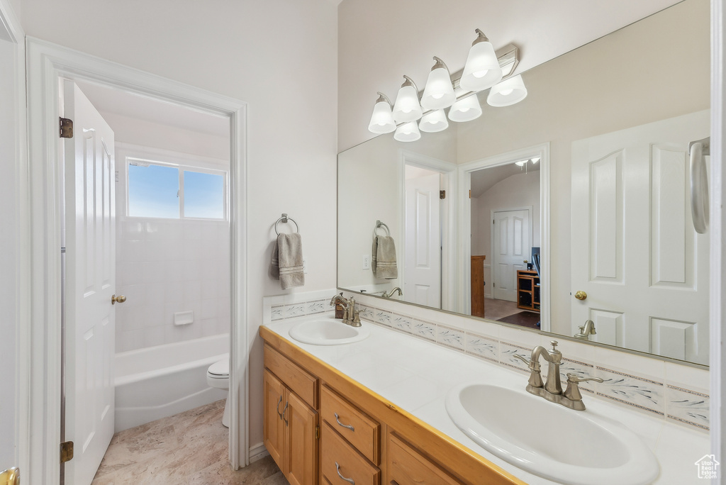 Bathroom with double vanity and toilet