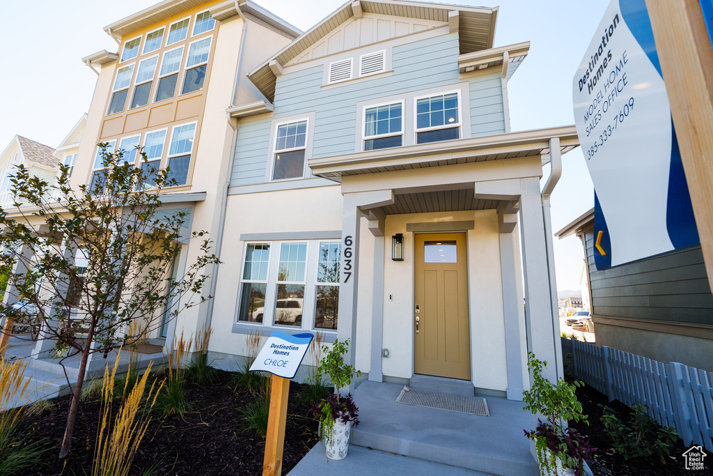 View of front of home featuring stucco siding and board and batten siding