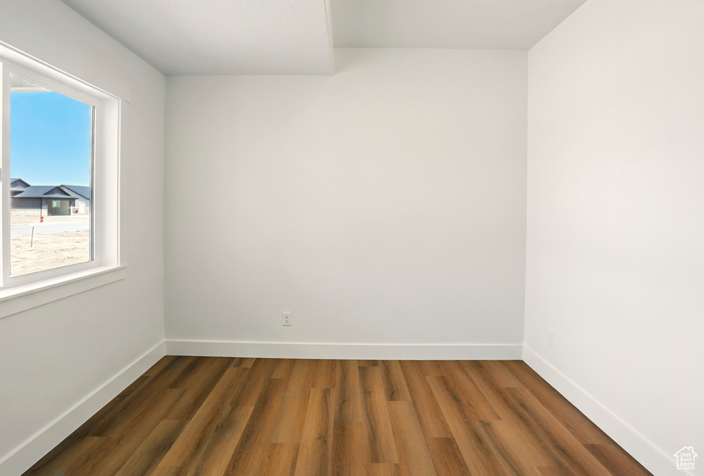 Spare room with dark wood-type flooring