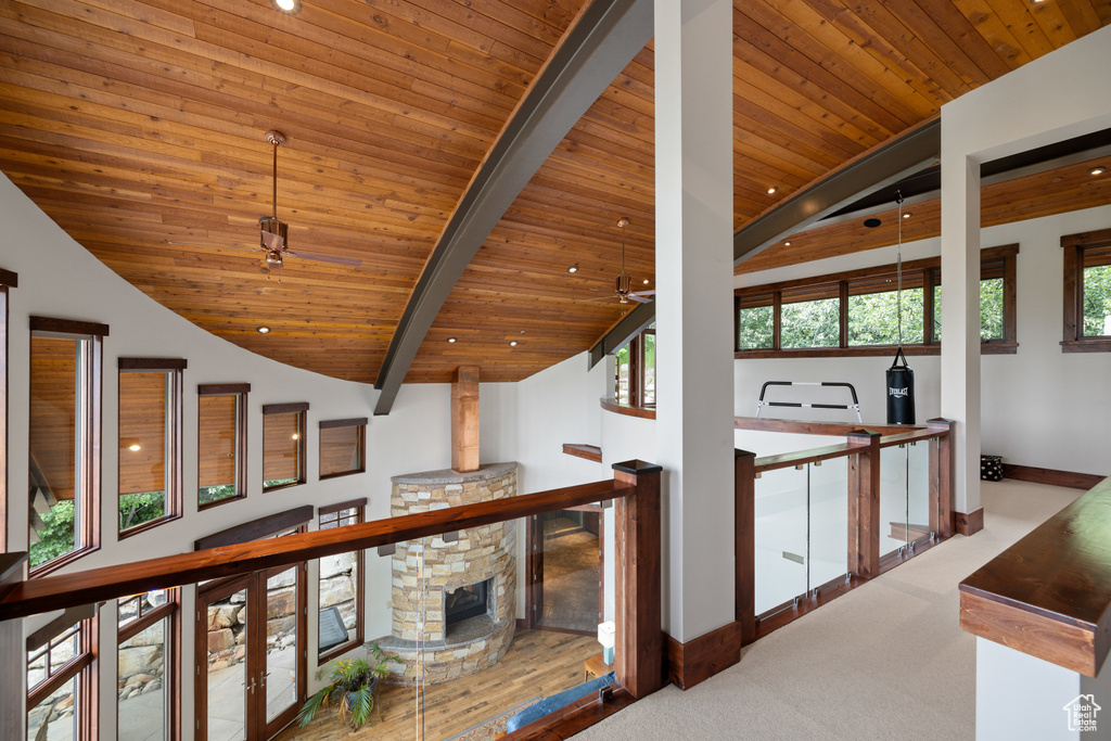 Hallway with wood ceiling, baseboards, and carpet flooring